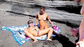 A girl undresses on the beach and plays with her pussy