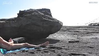 A girl undresses on the beach and plays with her pussy