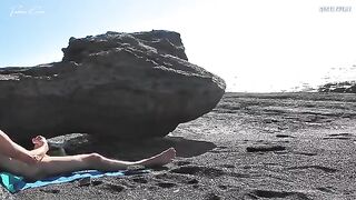 A girl undresses on the beach and plays with her pussy